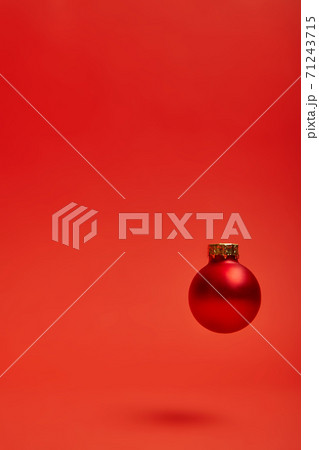 New Year's toy hovering in the air on a red background New Year's toy hovering in the air on a red background 71243715