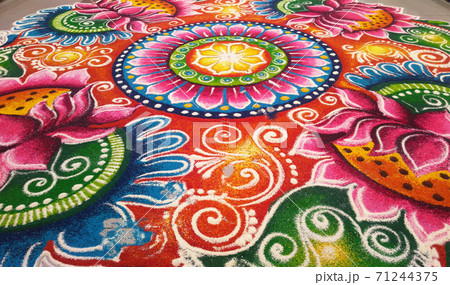 KUALA LUMPUR, MALAYSIA -OCTOBER 16, 2016: Rangoli. Colorful pattern made with colored rice, lentils and powder during Diwali, Hindu New Years and the Hindu Festival of Light. KUALA LUMPUR, MALAYSIA -OCTOBER 16, 2016: Rangoli. Colorful pattern made with colored rice, lentils and powder during Diwali, Hindu New Years and the Hindu Festival of Light. 71244375