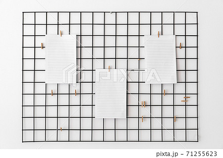 Blank paper attached with pegs on grid as notice, reminder or planing board for succesfully following tasks or goals. Blank paper attached with pegs on grid as notice, reminder or planing board for succesfully following tasks or goals. 71255623