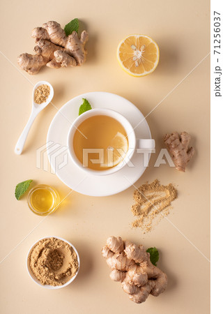 hot ginger tea with honey lemon and mint on a light background 71256037