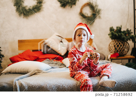 Cute boy eating delicious cookie at home Cute boy eating delicious cookie at home 71258692
