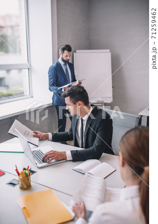 Two men and woman with documents in office Two men and woman with documents in office 71259462