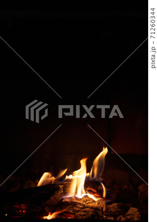 Wood burning in a fireplace to warm the house Wood burning in a fireplace to warm the house 71260344