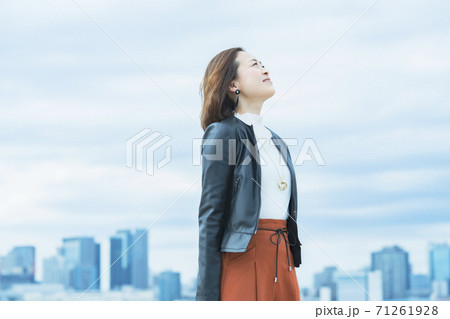 屋外で笑顔を見せるオフィスカジュアルスタイルの女性 屋外で笑顔を見せるオフィスカジュアルスタイルの女性 71261928