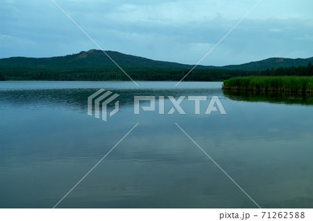 View to lake with mountain range on another shore View to lake with mountain range on another shore 71262588