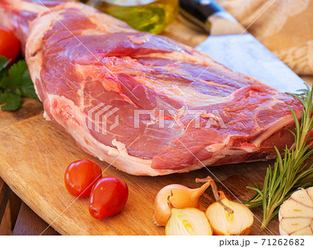 Fresh and raw meat. Leg of lamb on wood background 71262682