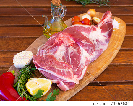 Fresh and raw meat. Leg of lamb on wood background Fresh and raw meat. Leg of lamb on wood background 71262686