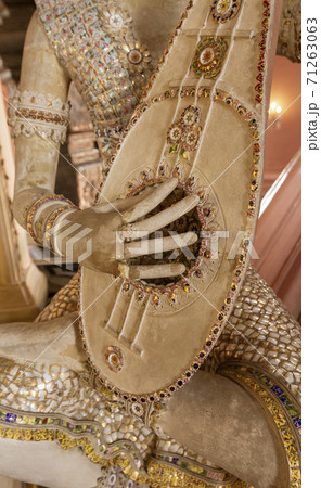 Statue of Imp God in Gangaramaya Temple in Colombo Sri Lanka - Playing Mandolin 71263063