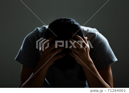 Sad and depressed man covering face Sad and depressed man covering face 71264001