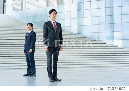 ビジネス 企業のロビーに立つ若い男性とミドルエイジの男性 ビジネス 企業のロビーに立つ若い男性とミドルエイジの男性 71264002
