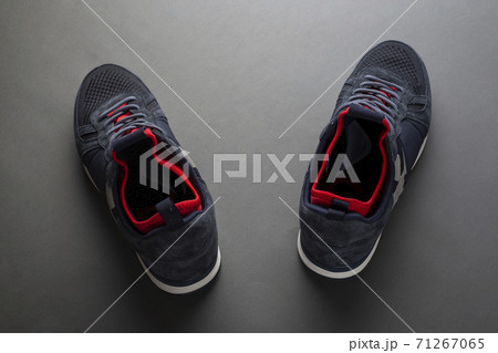Pair of insulated trendy sneakers on a gray background. 71267065