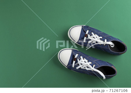 New blue gumshoes on green background 71267106