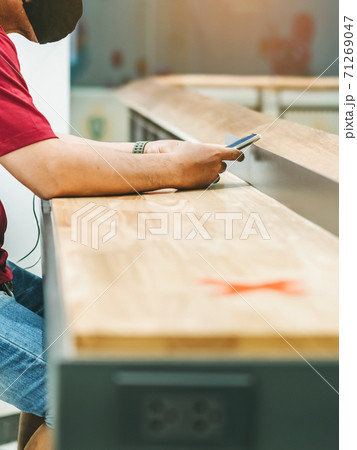 Man using mobile phones for work with blurred image of alternative seating mark for social distance rules distance for one seat from other people to protect from Corona Virus(COVID-19) in foreground Man using mobile phones for work with blurred image of alternative seating mark for social distance rules distance for one seat from other people to protect from Corona Virus(COVID-19) in foreground 71269047