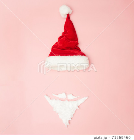 Christmas concert, New Year's hat and beard on a pink background, top view, copy space Christmas concert, New Year's hat and beard on a pink background, top view, copy space 71269460
