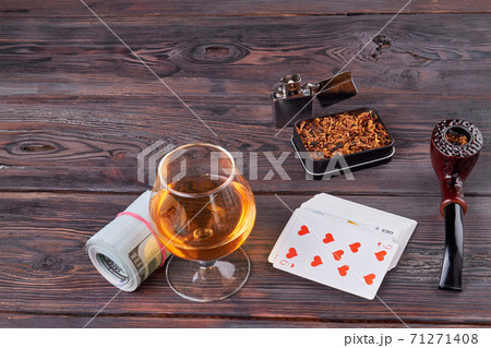 Gambling table with alcohol and smoking pipe. 71271408
