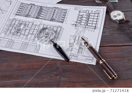Building layous with glass magnifier and pen. 71271418