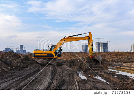 Excavator during excavation at construction site. Excavator during excavation at construction site. 71272153
