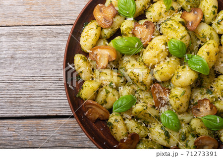 Homemade potatoes gnocchi with basil , cheese and mushrooms Homemade potatoes gnocchi with basil , cheese and mushrooms 71273391