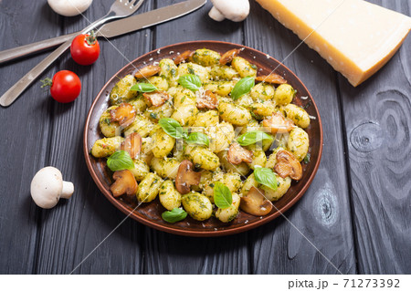 Homemade potatoes gnocchi with basil , cheese and mushrooms 71273392