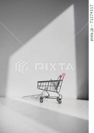 Shopping cart isolated on white background. Safe online shopping on quarantine concept. Empty supermarket shopping trolley with copy space 71274317