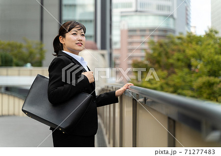 ビジネス街を歩く若い女子社員/就職活動をする女性 ビジネス街を歩く若い女子社員/就職活動をする女性 71277483