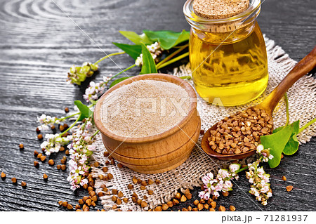 Flour buckwheat brown in bowl with oil on dark wooden board Flour buckwheat brown in bowl with oil on dark wooden board 71281937
