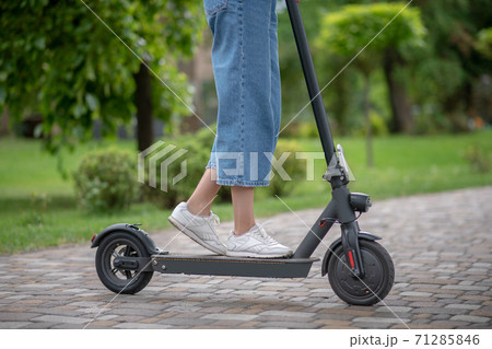 Close up picture of woman legs standing on a scooter 71285846