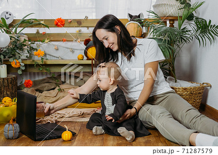 Thanksgiving online party, virtual dinner gathering. Holidays in the Time of COVID new normal, Pandemic time. Happy family, friends, mother and baby celebrating Thanksgiving via internet near laptop 71287579