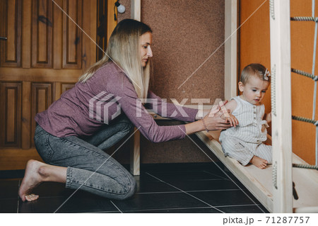 Active games for Baby indoors activities. Toddler girl play with mom on home Wooden playsets. Play Gym, Home and School Indoor Wooden Playground Equipment for kids Children with Climbing Net, Slide 71287757