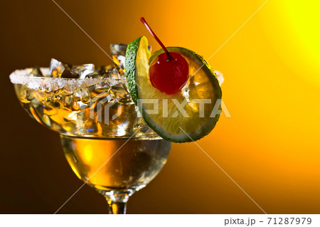 Alcoholic cocktail with cherry and lime. Alcoholic cocktail with cherry and lime. 71287979