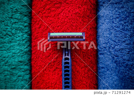 The razor lies on fresh colored towels 71291274