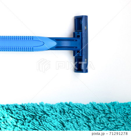The razor lies near a green towel The razor lies near a green towel 71291278