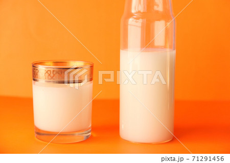 close up of bottle of milk on orange background  71291456