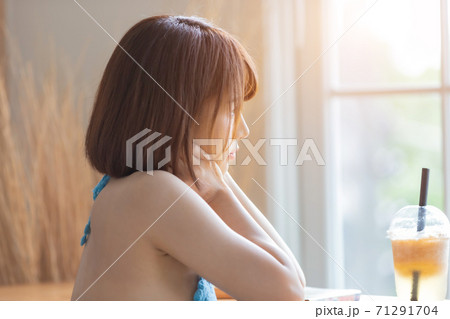 Portrait of young pretty sexy Asian woman wearing blue bikini in her room. Portrait of young pretty sexy Asian woman wearing blue bikini in her room. 71291704