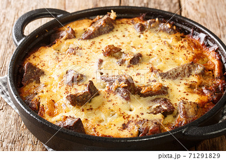 Tave kosi is a national Albanian dish of baked lamb and rice with yoghurt close-up in a pan. horizontal 71291829