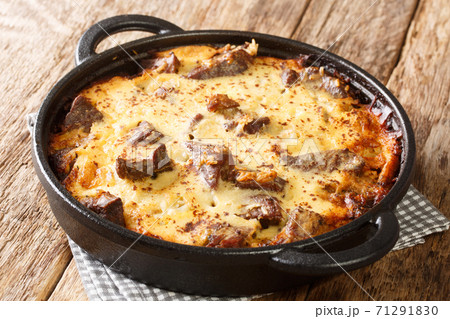 Albanian Baked Lamb and Rice with Yogurt Tave Kosi close-up in a pan. horizontal 71291830