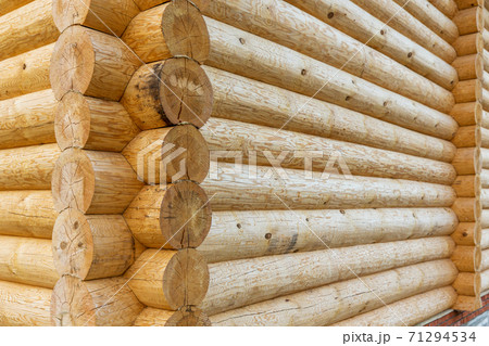 corner of wooden house made of natural logs 71294534