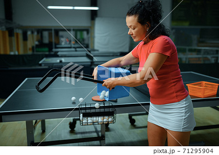 Woman with basket of ping pong balls, table tennis Woman with basket of ping pong balls, table tennis 71295904