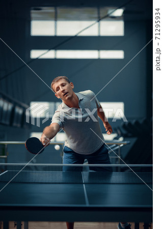 Man hits the ball at the net, table tennis 71295934