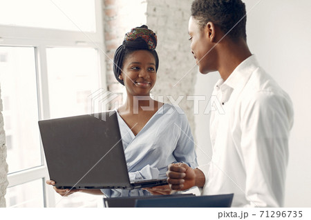 Black people standing on a white background with a laptop Black people standing on a white background with a laptop 71296735