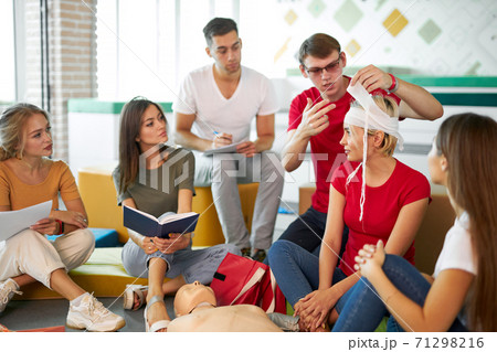 group of people practice treating a patient by bandages group of people practice treating a patient by bandages 71298216