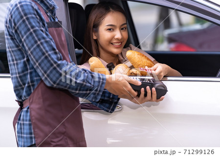 asian woman making contactless payment for grocery 71299126