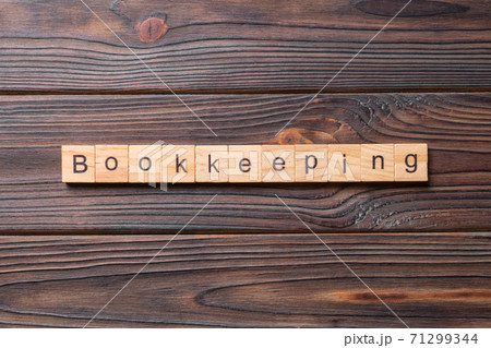 bookkeeping word written on wood block. bookkeeping text on table, concept 71299344