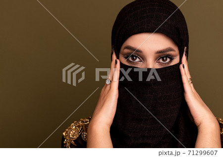 Muslim woman in hijab. Portrait of a young arab girl in traditional dress.  71299607