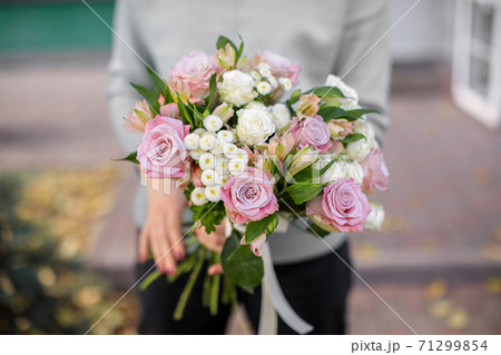 Handsome fresh bouquet. Flowers delivery. Woman florist. Beautiful bouquet of mixed flowers. Floral shop concept 71299854