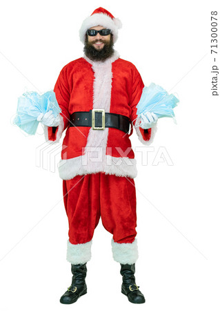 Arabic Santa Claus with black beard holds covid medical mask or respirators epidemic or coronavirus protection. Arabic Santa Claus with black beard holds covid medical mask or respirators epidemic or coronavirus protection. 71300078
