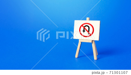 Easel with no turning back traffic sign. Turn arrow and red prohibition symbol. Assertiveness and striving, moving forward without retreating. Finish goals. No way back. Obstinacy, irrevocability 71301107