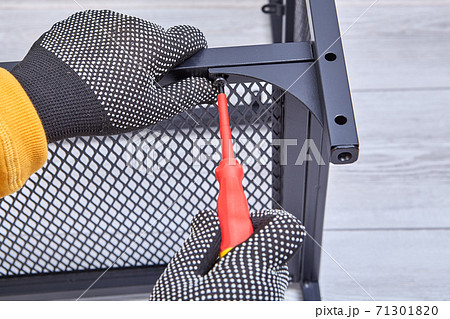 Building flat packed furniture DIY with help of screwdriver at home. 71301820