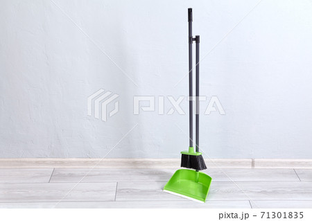 Broom and brush for cleaning flat stands on floor fastened together. Broom and brush for cleaning flat stands on floor fastened together. 71301835