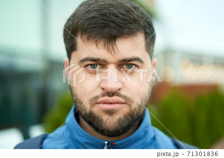 Young white bearded attractive man with serious look outdoor. Young white bearded attractive man with serious look outdoor. 71301836